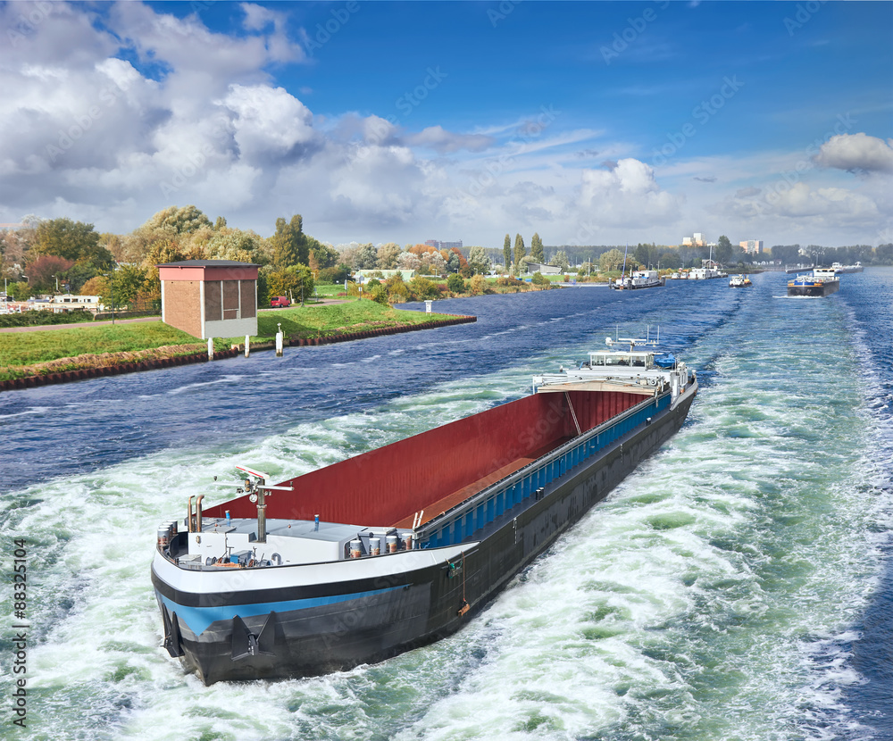 Naklejka premium Barge on the Amsterdam in summer day