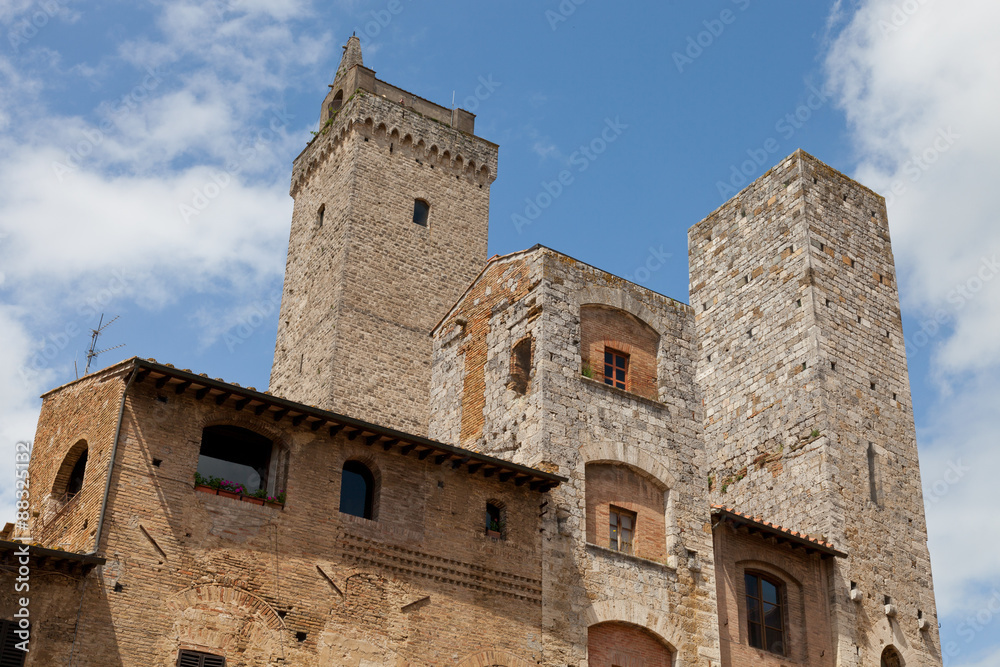 Buildings and towers overlooking Piazza della Cisterna, San Gimignano, Siena, Tuscany Buildings and towers overlooking Piazza della Cisterna, San Gimignano, Siena, Tuscany