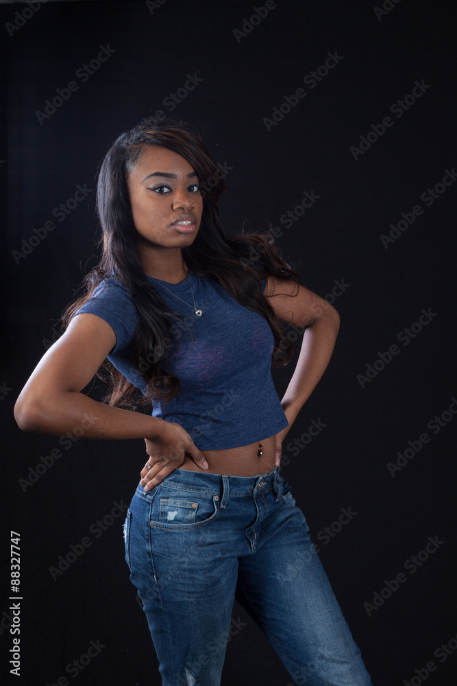 Thoughtful black woman with hands on hips Thoughtful black woman with hands on hips