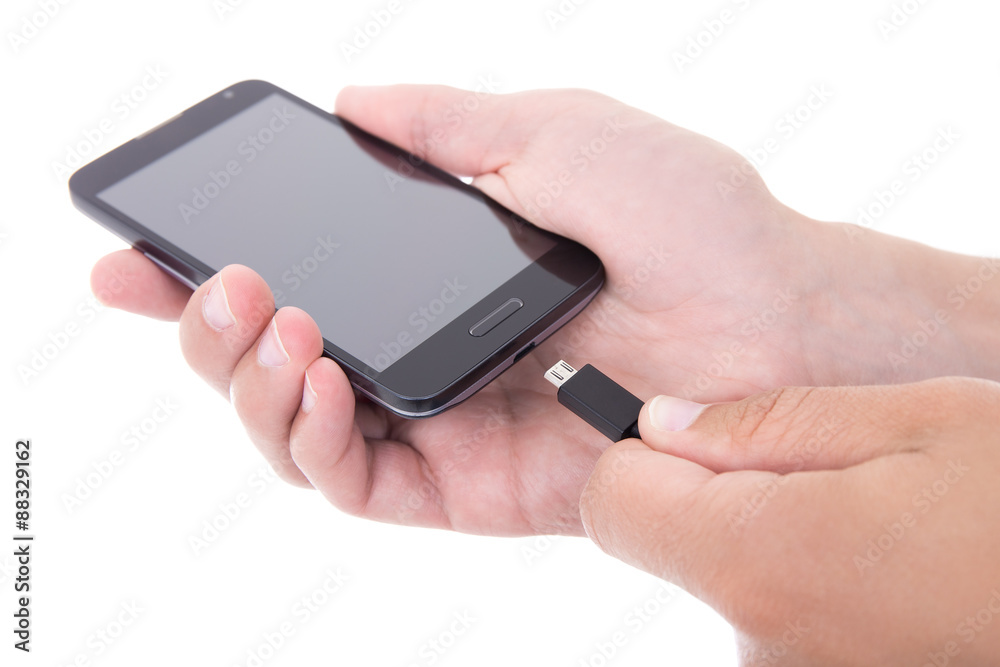 smart phone with blank screen and charger in hand isolated on wh smart phone with blank screen and charger in hand isolated on wh