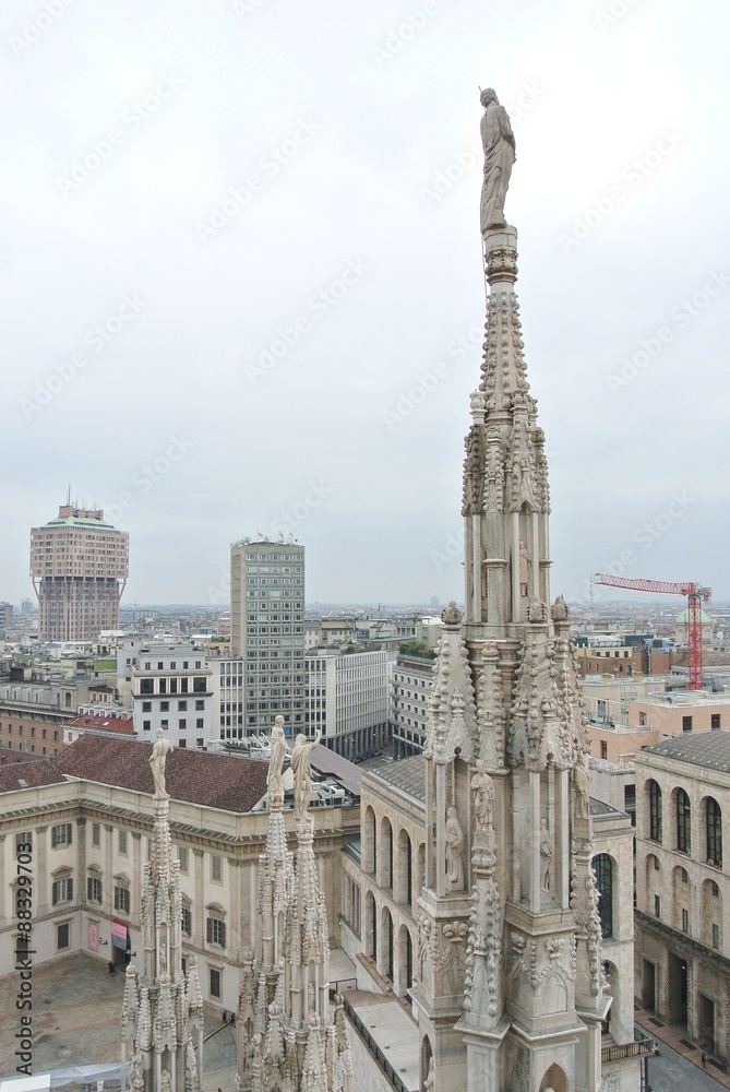 Architectural details from the roof of Milan Cathedral (Duomo di Milano) built in Gothic style, in white marble. Architectural details from the roof of Milan Cathedral (Duomo di Milano) built in Gothic style, in white marble.