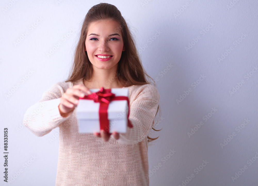 Young woman happy smile hold gift box in hands,standing over Young woman happy smile hold gift box in hands,standing over