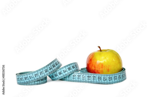 Apple and measuring tape isolated on white background