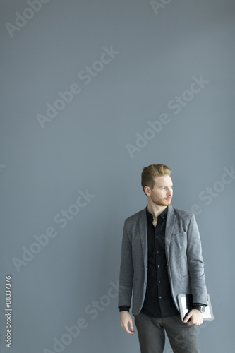 Young man with tablet by th...