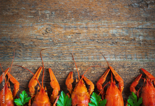 Boiled crayfish on a wooden background.
