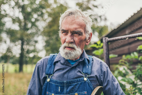Konstfotografi Serious grey haired senior farmer