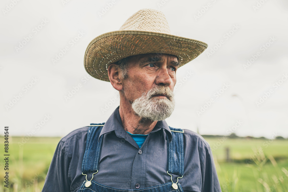 Thoughtful Senior Male Farmer with Straw Hat
