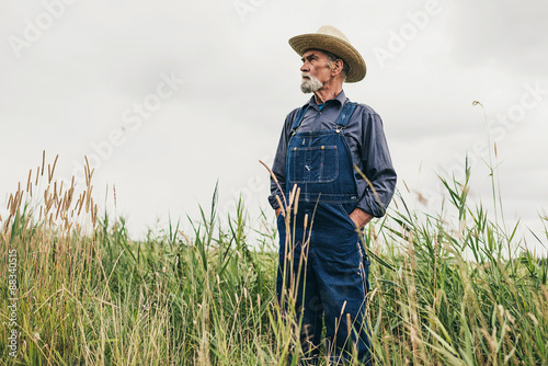 Photography Senior Male Farmer with Hat Standing at the Farm