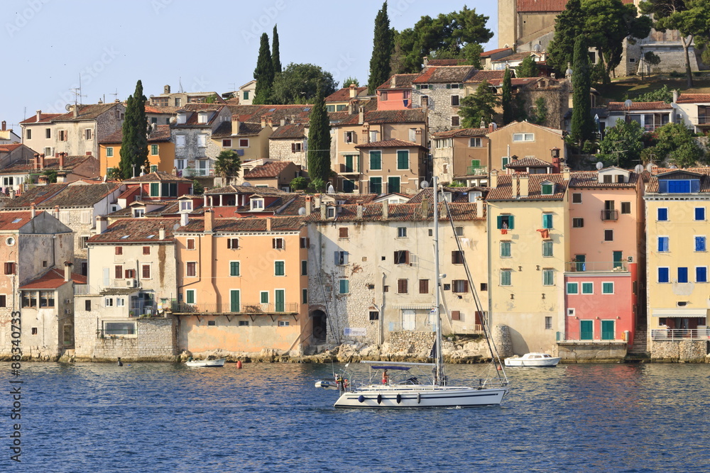 Yacht and Old Town from the sea on a summer's early morning, Rovinj (Rovigno) peninsula, Istria, Croatia Yacht and Old Town from the sea on a summer's early morning, Rovinj (Rovigno) peninsula, Istria, Croatia