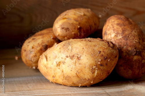 Potatoes.  Potatoes on a wooden surface.