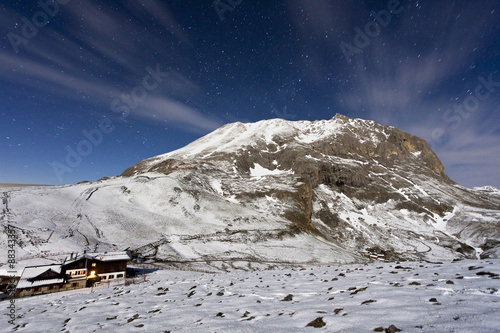 The mountain hut at the foot of Plattkofel (Sasso Piatto) under a starry winter night, South Tyrol, Trentino-Alto Adige photo