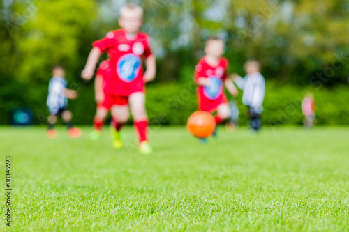 Blurred kids playing youth football match