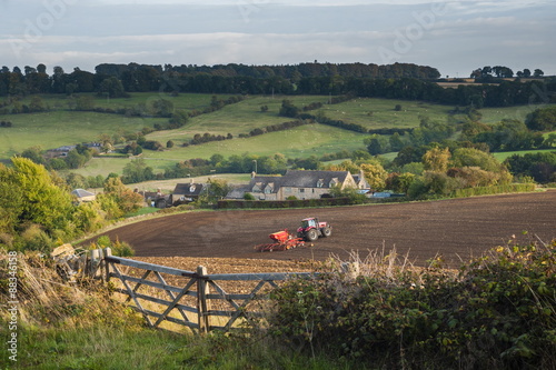 Tractor ploughing fields in Blockley, The Cotswolds, Gloucestershire  photo