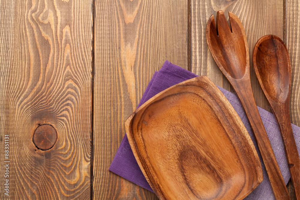 Wood kitchen utensils over wooden table background Wood kitchen utensils over wooden table background