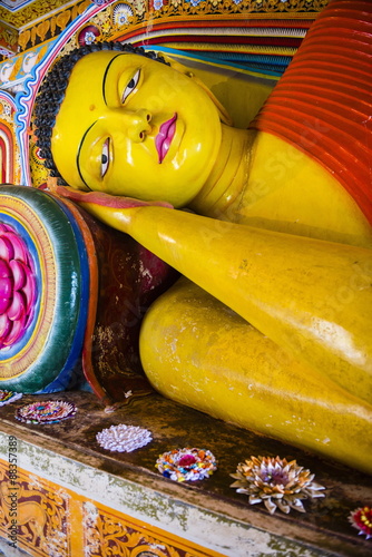 Colourful reclining Buddha statue at Isurumuniya Vihara, Anuradhapura, Sri Lanka,Asia