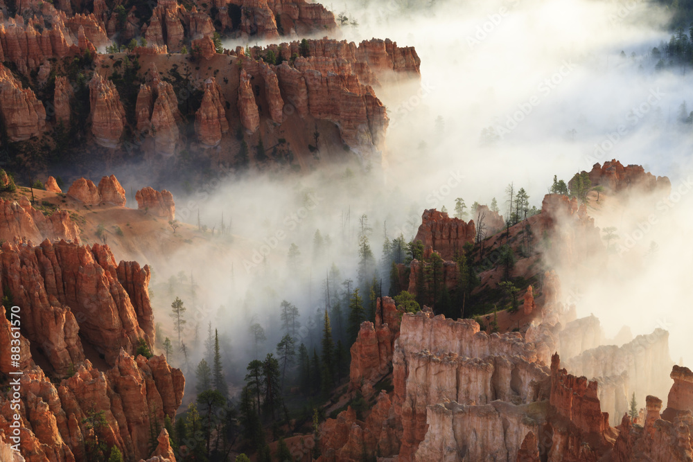 Foto de Pinnacles and hoodoos with fog extending into clouds of a