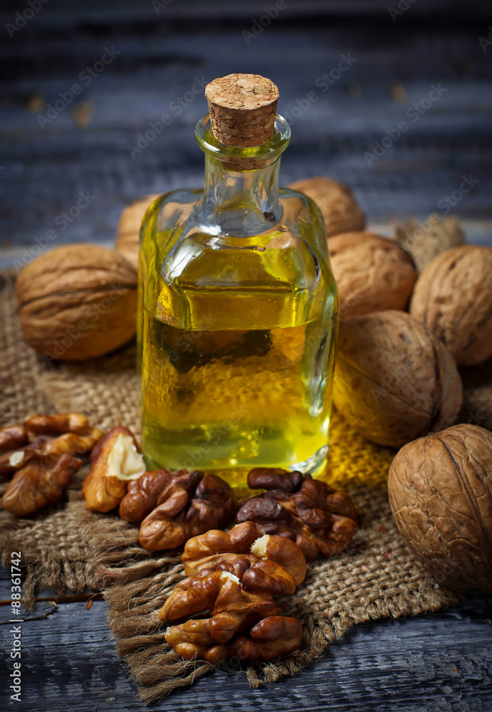 Walnut oil in bottle and nuts Walnut oil in bottle and nuts