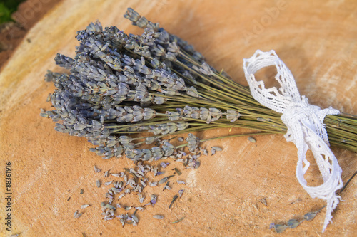 Small bouquet of dry lavender on a wooden background