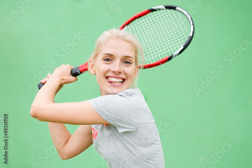 Girl tennis player on the court with a racket. © ilya_oreshkov