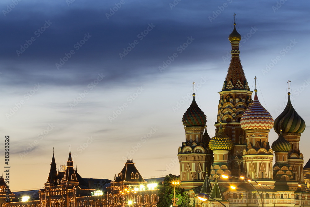 The onion domes of St. Basil's Cathedral and Gum department store in Red Square illuminated at night, Moscow, Russia The onion domes of St. Basil's Cathedral and Gum department store in Red Square illuminated at night, Moscow, Russia