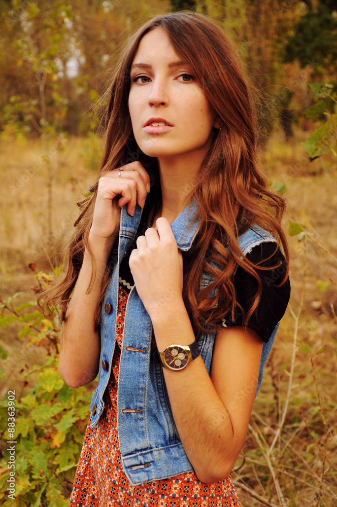 Naklejka premium Cute young woman in the autumn forest