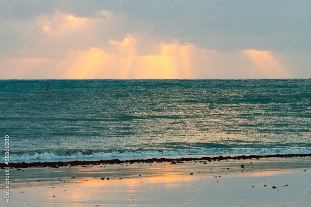 Sky reflection on the ocean shore at sunrise
