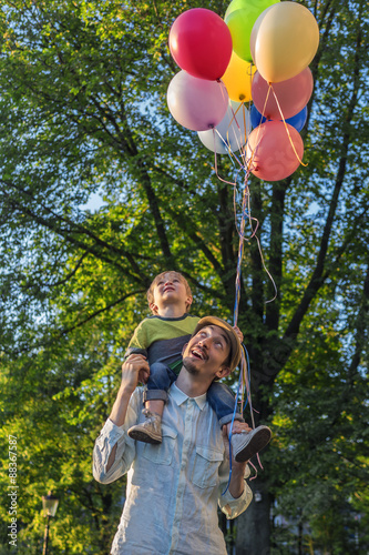 Father and son in the park with balloons