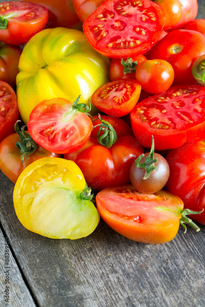 assorted tomatoes on wooden surface assorted tomatoes on wooden surface