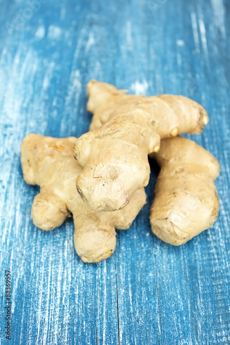 Fresh ginger root on wooden background