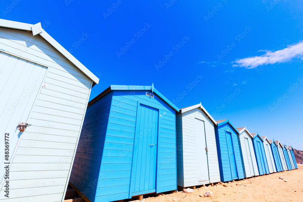 Reihe blauer Umkleidekabinen an der englischen Kanalküste