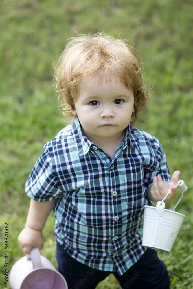 Small boy with watering-can and bucket Small boy with watering-can and bucket