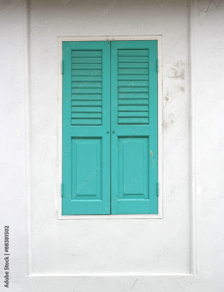 Green wood window on a white wall