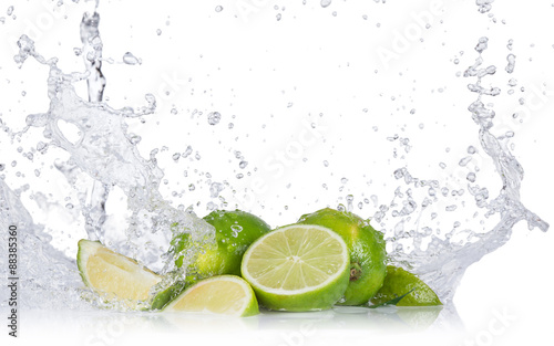 Fresh limes with water splashes