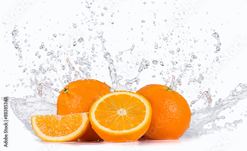 Fresh oranges with water splashes.