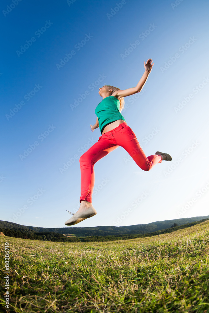 Happy girl jumping in nature, image shot with fish-eye lens Happy girl jumping in nature, image shot with fish-eye lens