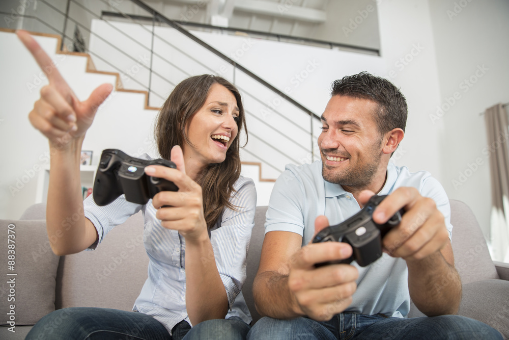 Fototapeta premium Young couple playing video game