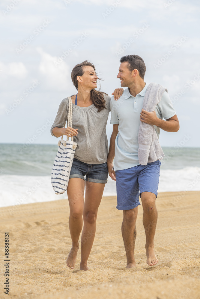 Young couple walking on the beach