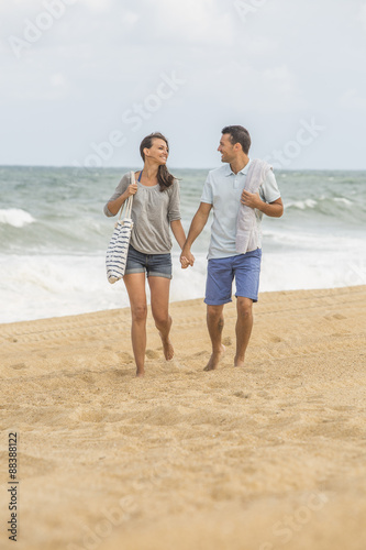 Young couple walking on the beach