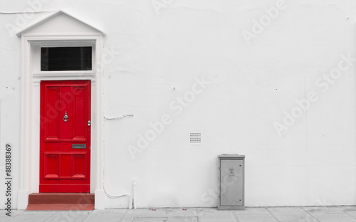 Red wooden door with silver mail door slot and door knocker