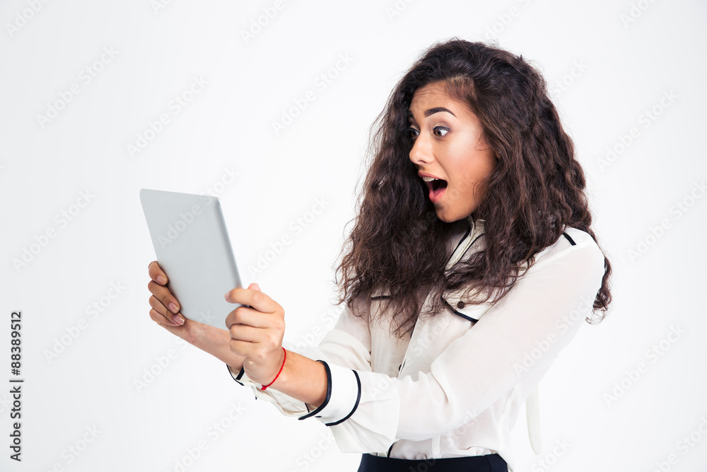 Surprised businesswoman looking at tablet computer Surprised businesswoman looking at tablet computer