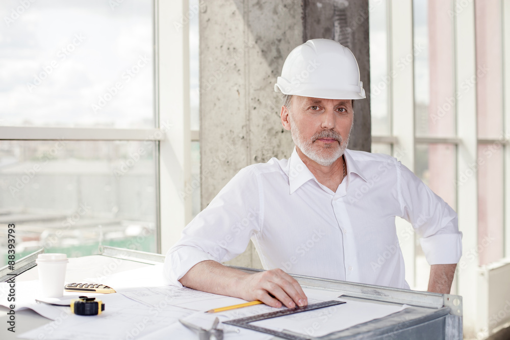 Cheerful old architect is working with new project Cheerful old architect is working with new project