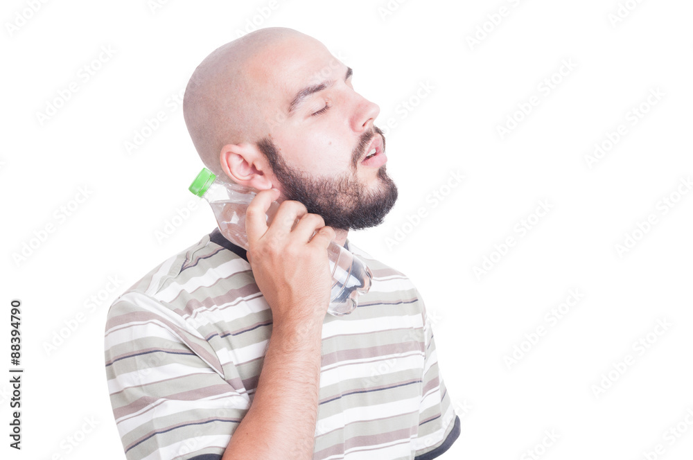 Man cooling his neck with cold water in plastic bottle Man cooling his neck with cold water in plastic bottle