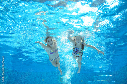 Photography Children swim in pool underwater, happy active girls have fun in water