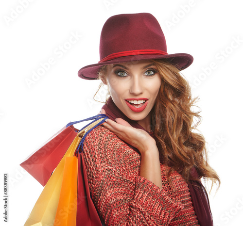 Shopping woman holding bags . smiling girl portrait on white stu