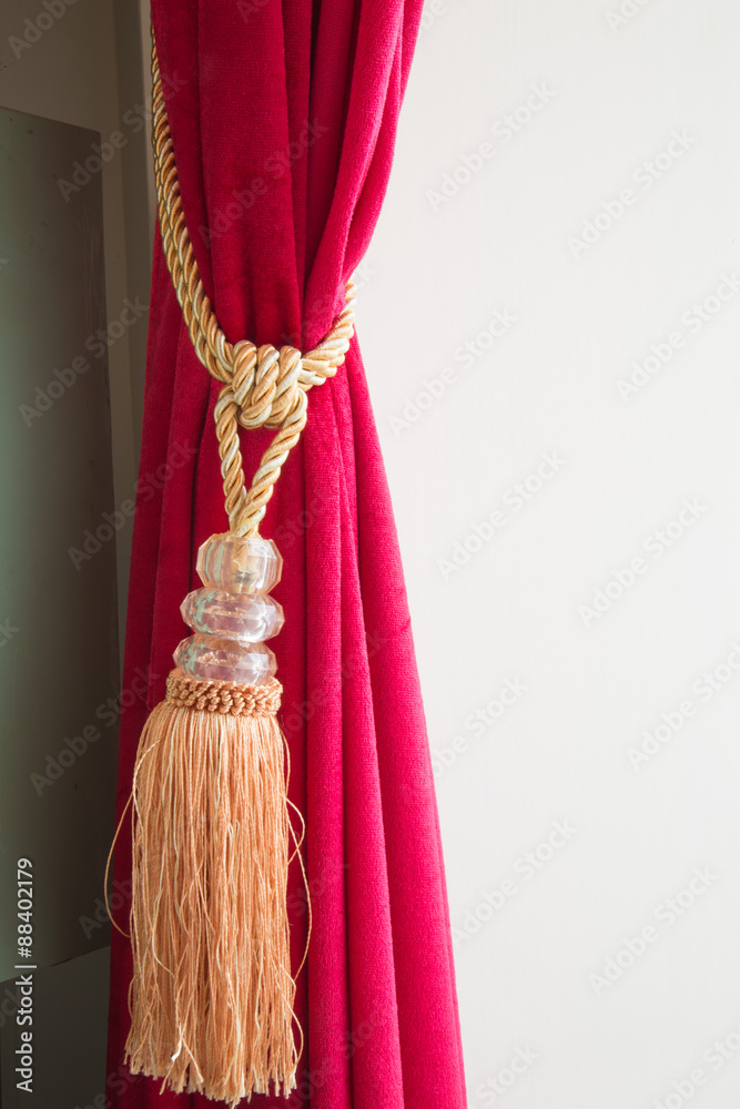 Red curtain with knot and tassel