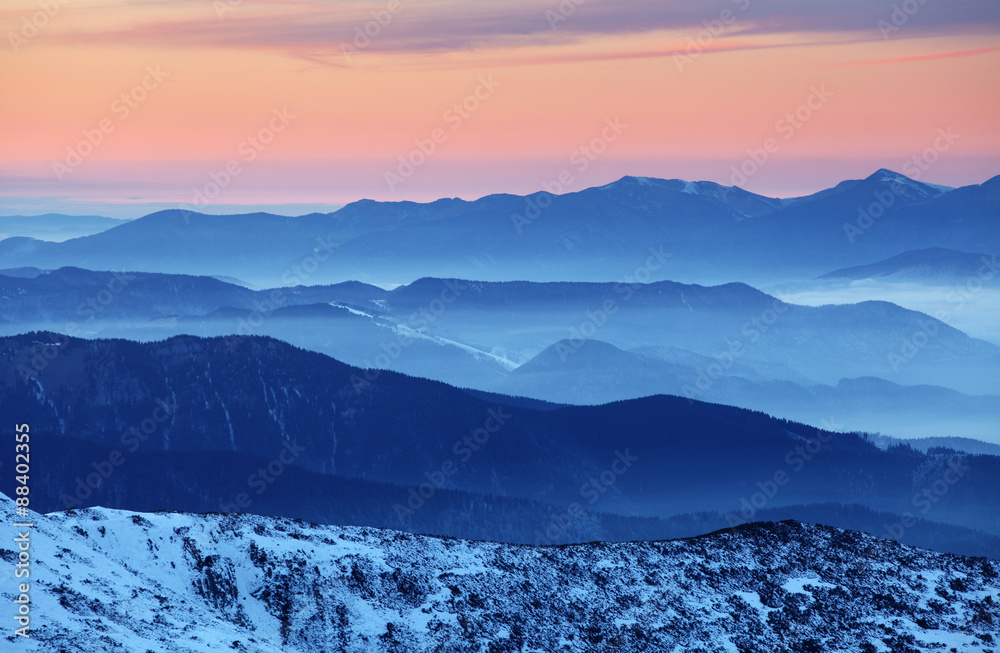 Obraz premium Sunset over color mountain silhouette.