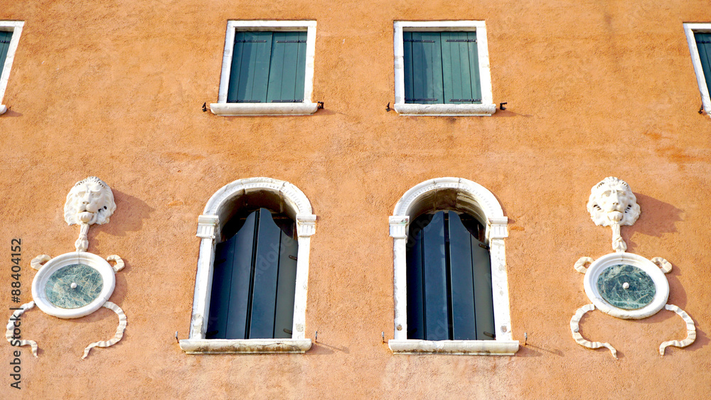 Windows on orange brown wall building