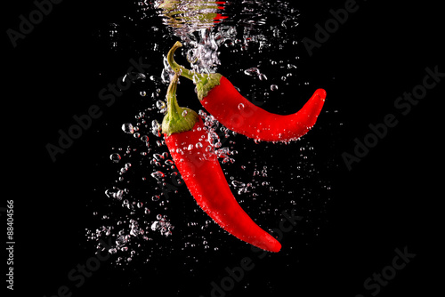 Czerwona papryka wpadająca do wody © CUKMEN