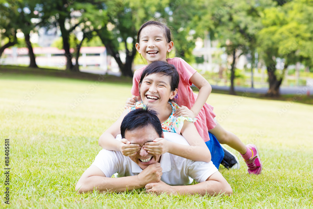 happy father and little girl lying on the grass happy father and little girl lying on the grass