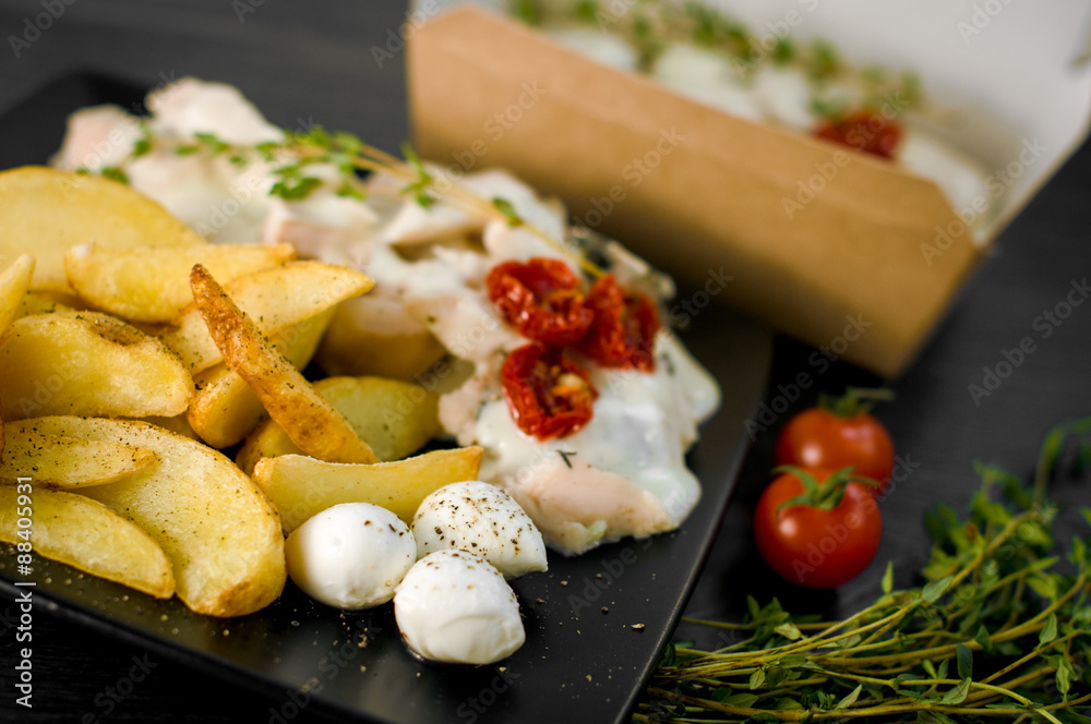 Delicious portion of rustic potatoes fillet with aromatic herbs Delicious portion of rustic potatoes fillet with aromatic herbs